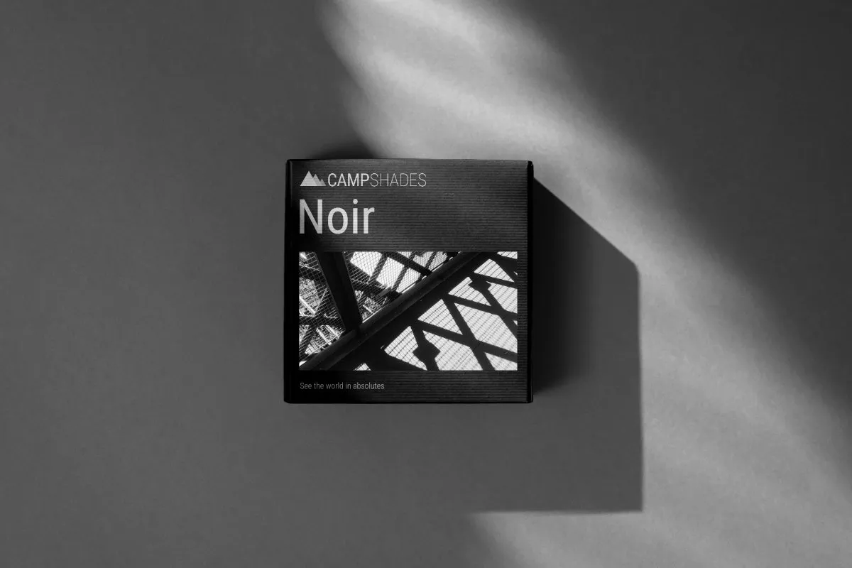 Black box on a shadowed grey background with a high contrast striking geometric photograph on the front