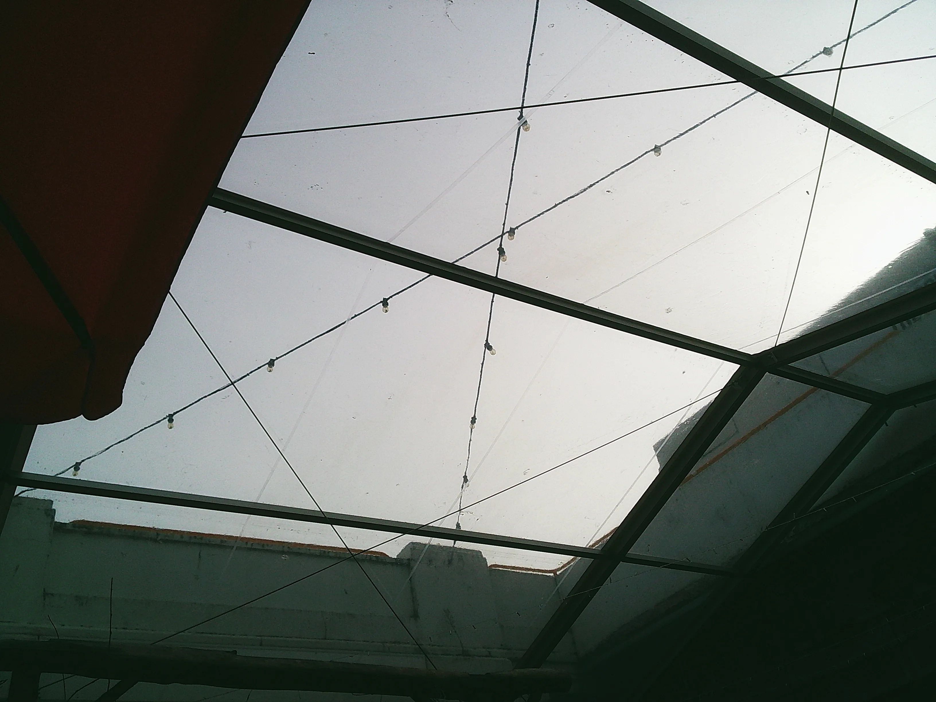 Geometric shapes created by a plastic roof with wires crossing between supports
